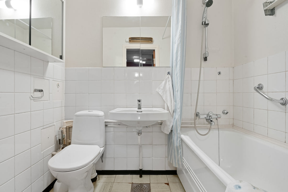 A white bathroom with a tub, toilet and sink