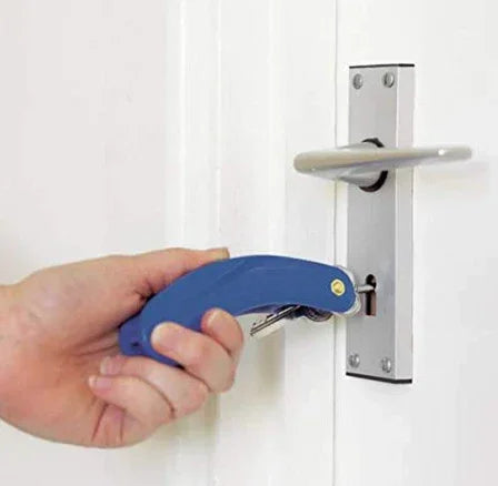 Hand using blue folding key tool to unlock white door with silver handle and lock