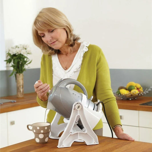 Homecraft kettle tipper for disabled users, allowing easy pouring with one hand in kitchen settings