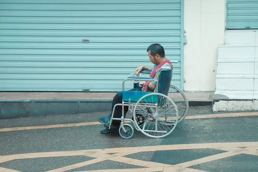 man in red shirt sitting on wheelchair