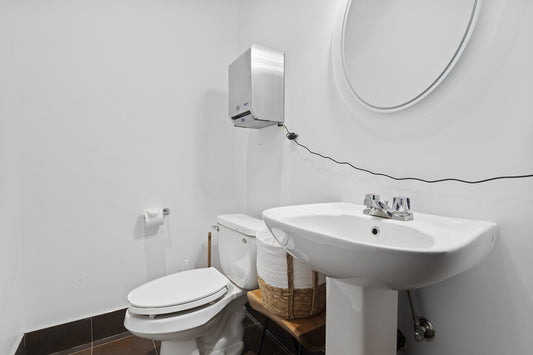 a bathroom with a sink toilet and mirror