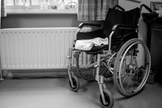 a wheelchair sitting in a room next to a radiator