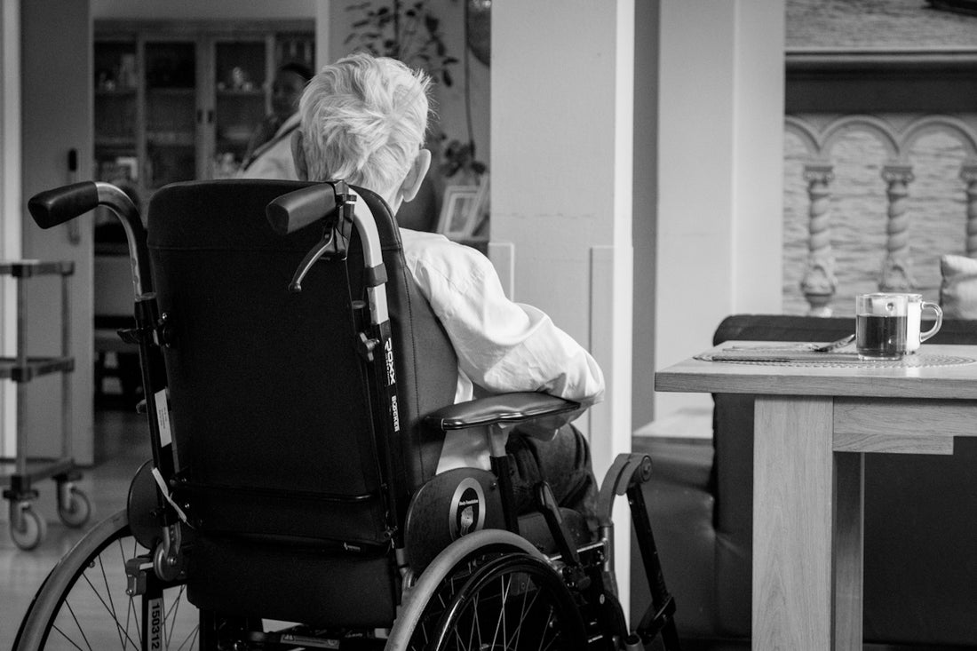 a woman in a wheel chair with a cup of coffee