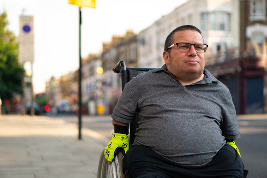 a man in a wheelchair on a city street