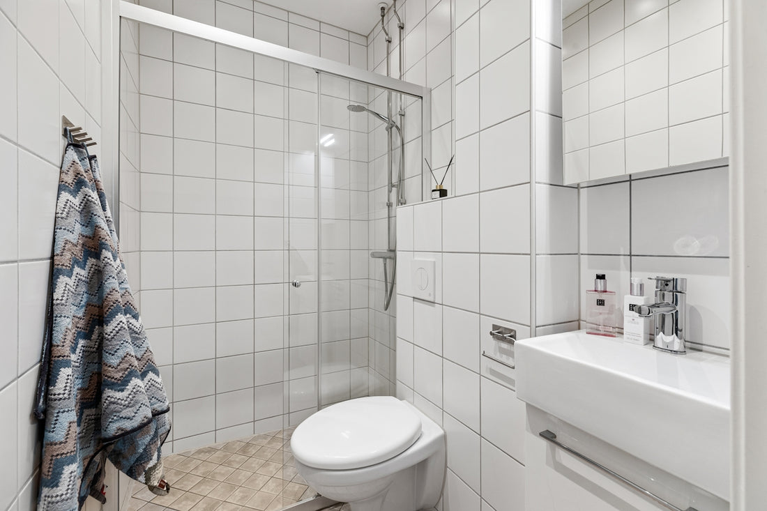 A bathroom with a toilet, sink, and shower