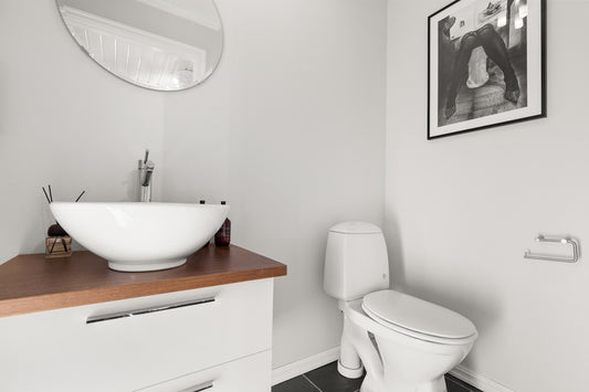 A bathroom with a sink, toilet and mirror