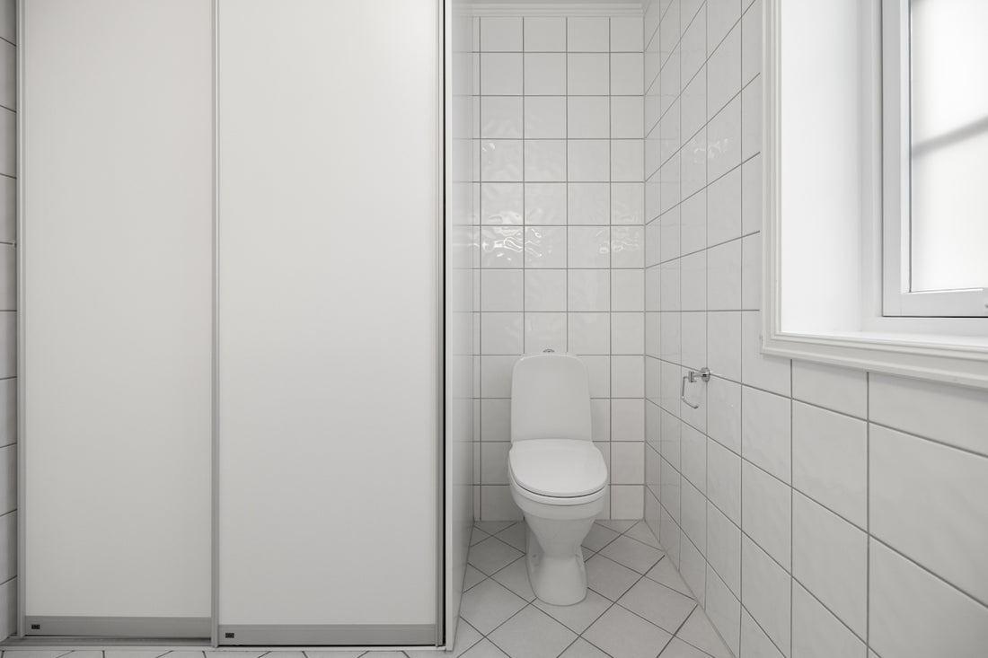 A bathroom with a toilet and a shower stall