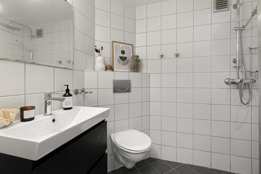 A bathroom with a sink, toilet, and shower
