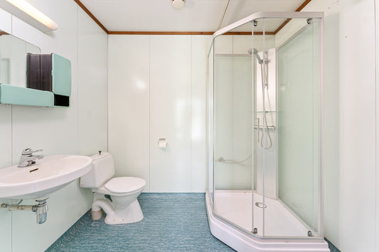 A bathroom with a toilet, sink, and shower