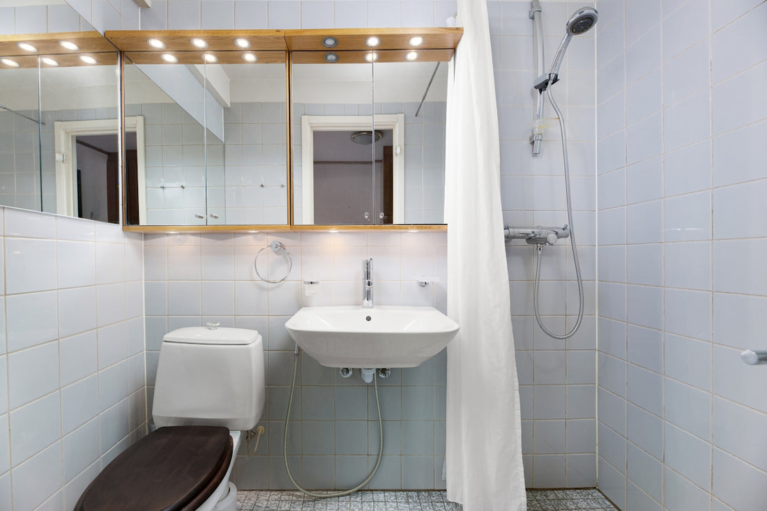 A bathroom with a toilet, sink, and shower