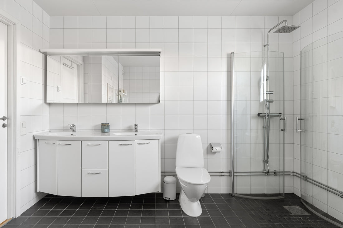 A bathroom with a toilet, sink, and shower