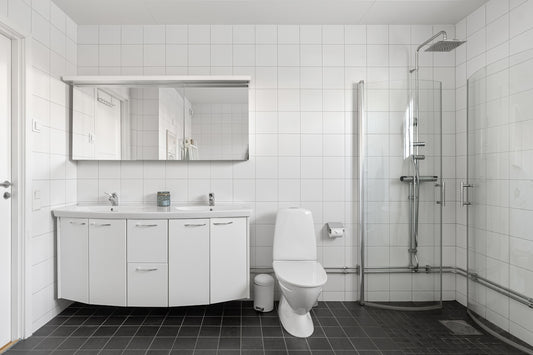 A bathroom with a toilet, sink, and shower