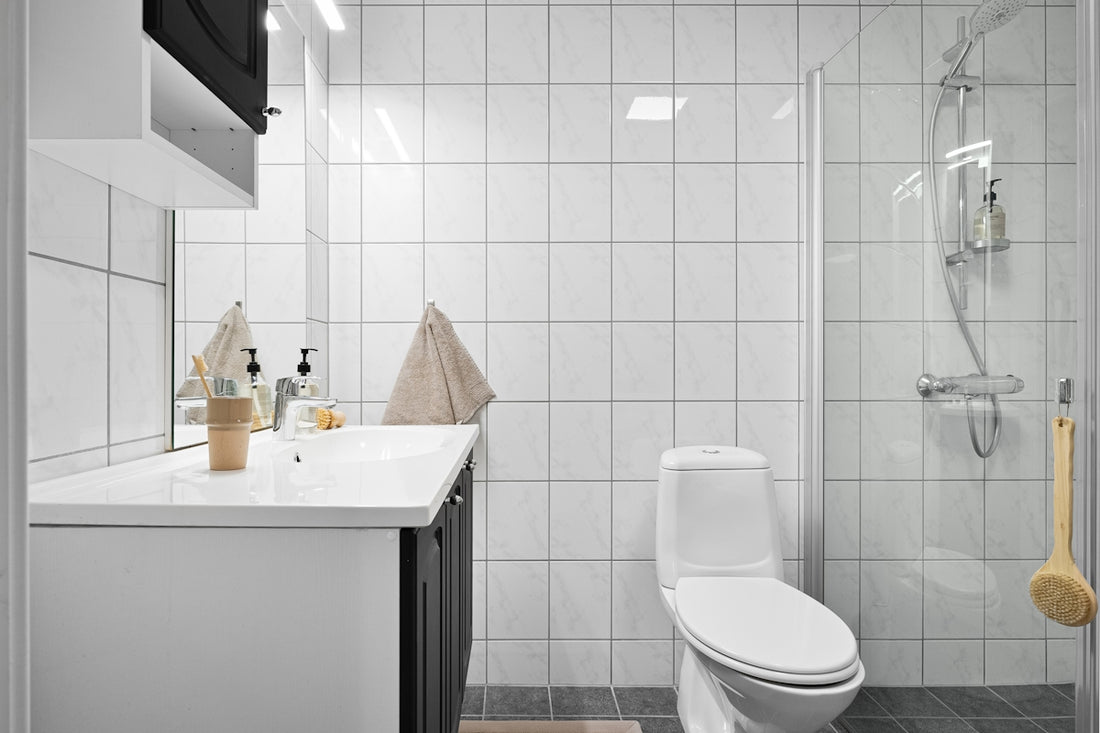 A bathroom with a toilet, sink, and shower