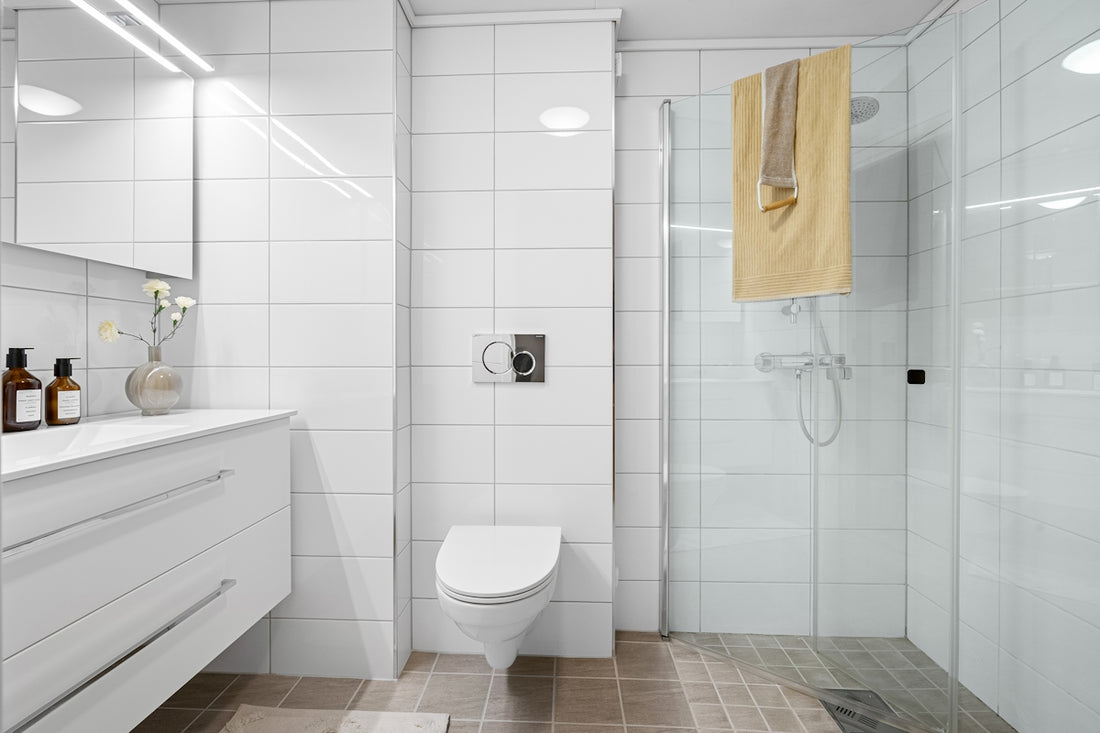 A bathroom with a toilet, sink, and shower