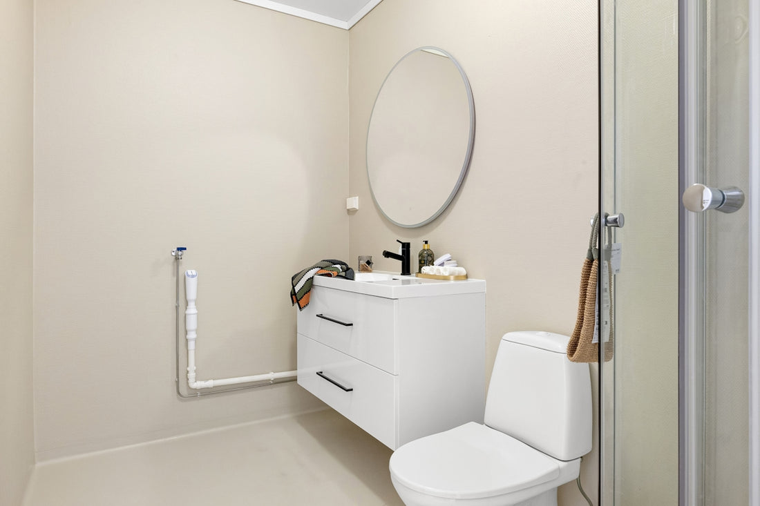 A bathroom with a toilet, sink, and shower