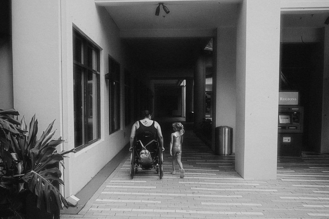 A man pushing a stroller down a hallway