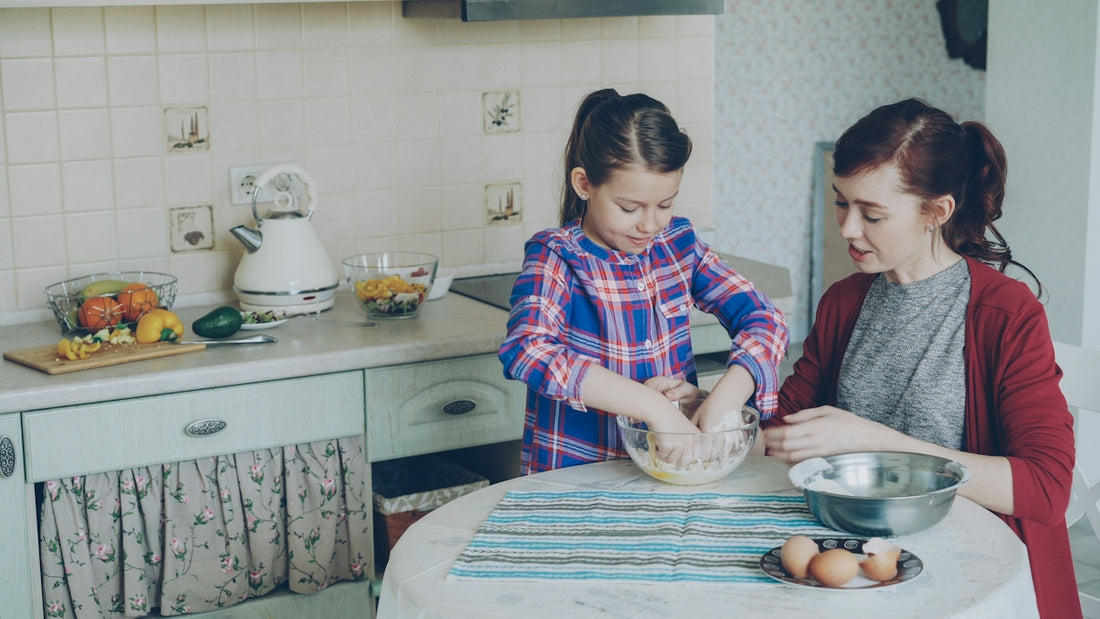 Mother and daughter are baking together in the kitchen.