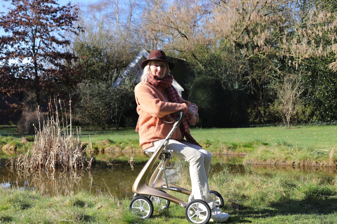 Elderly woman with walker sitting by a pond