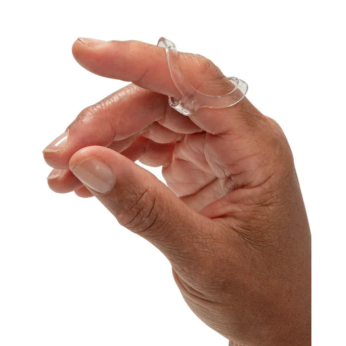 Hand wearing a clear oval silicone ring on the finger against white background