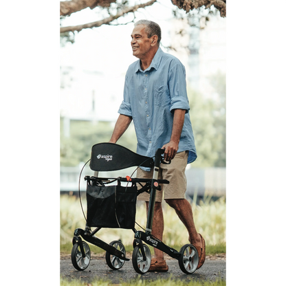 Smiling elderly man in blue shirt using black Aspire Vogue rollator walker outdoors