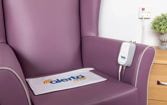 Alerta chair sensor alarm for elderly on a purple armchair, enhancing safety and fall prevention